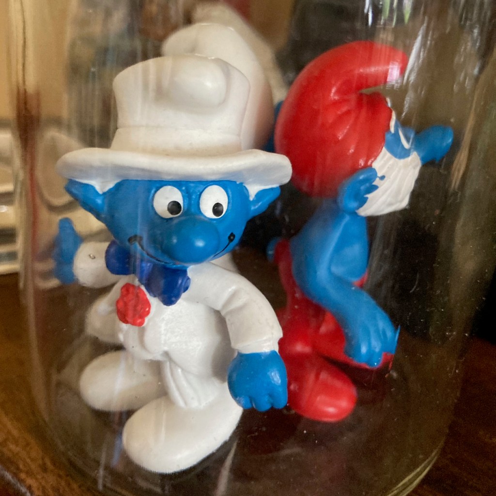 A well dressed smurf invites you to click on 'Poem of the Month'.